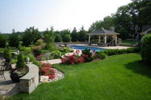 grass and patio space with a large pool in northern virginia