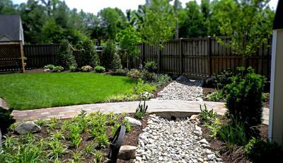 French drain with rock and a bridge Leesburg landscaping services